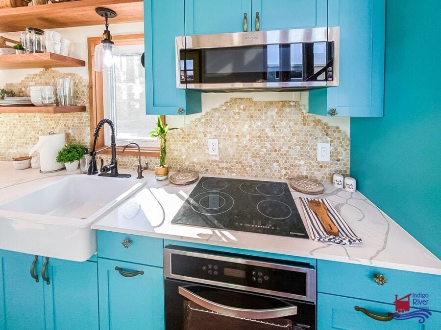 Unique textured tile backsplash featured in the Entertainer model tiny house kitchen by Indigo River Tiny Homes.