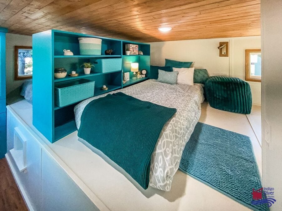 Kids’ rooms divided by a built-in bookshelf in the family-friendly Tree House tiny home.
