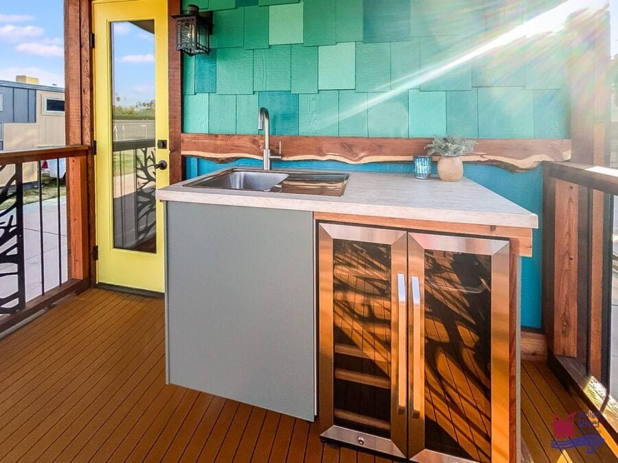 Outdoor drink fridge on the balcony of the Indigo River Tiny Homes Entertainer model.