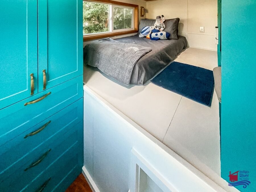 Spacious built-in wardrobes providing clothing storage in a 3-bedroom tiny house on wheels.