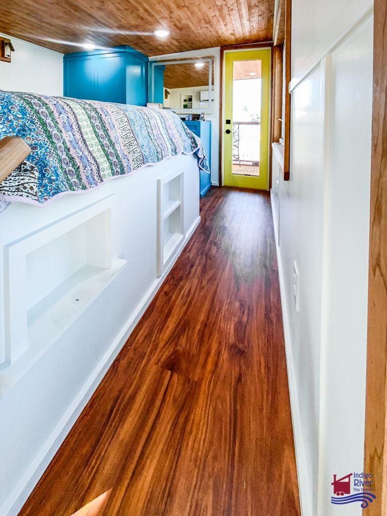 Hallway opening directly onto the 80-square-foot balcony in the Entertainer tiny house.