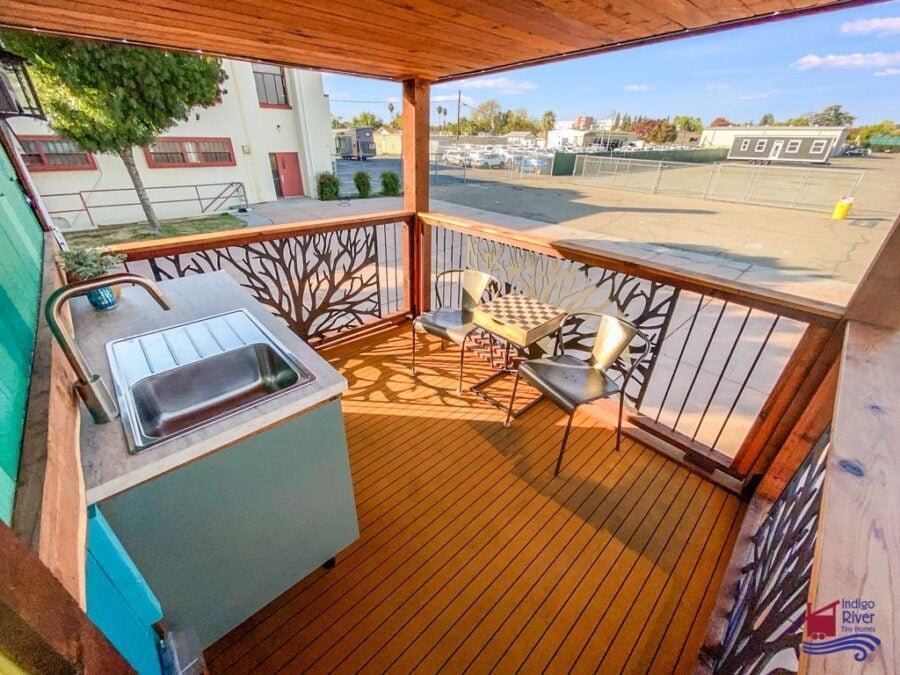 Outdoor balcony kitchen on the 80-square-foot upper deck of the Tree House tiny home.