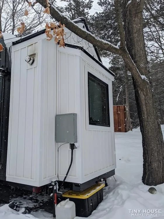 Side view of 36-foot family tiny house with clean modern exterior design