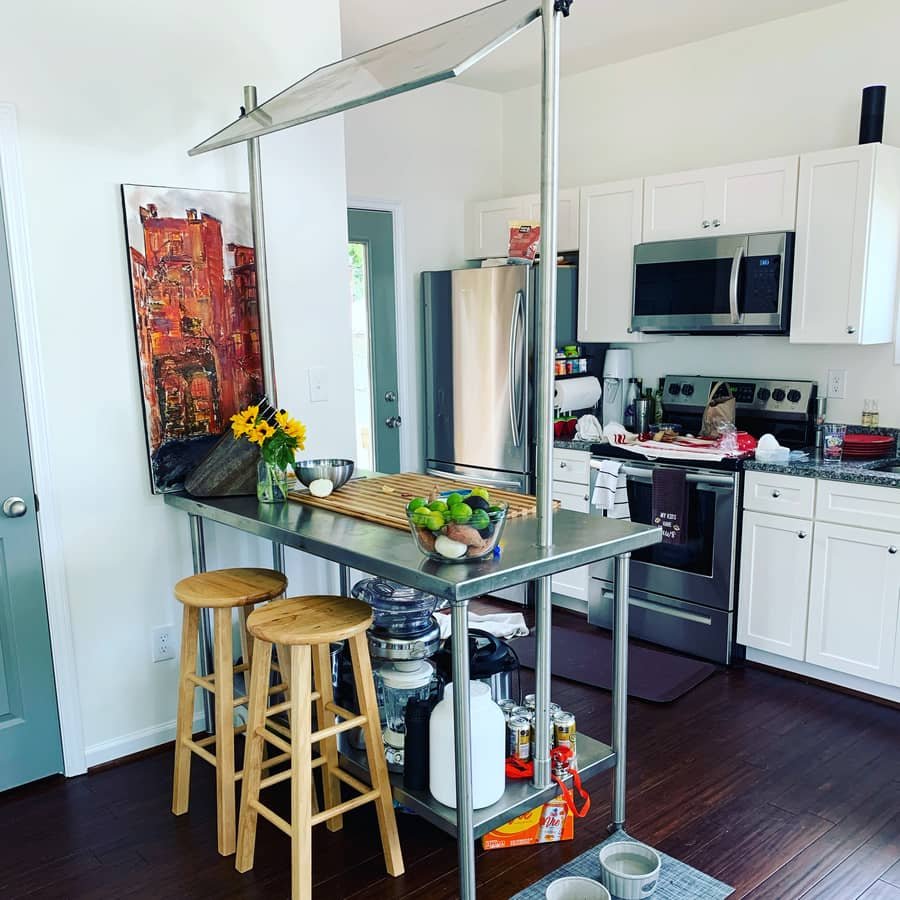 Additional kitchen angle showing cabinetry, wood finishes, and efficient design inside a Vaughn cottage.