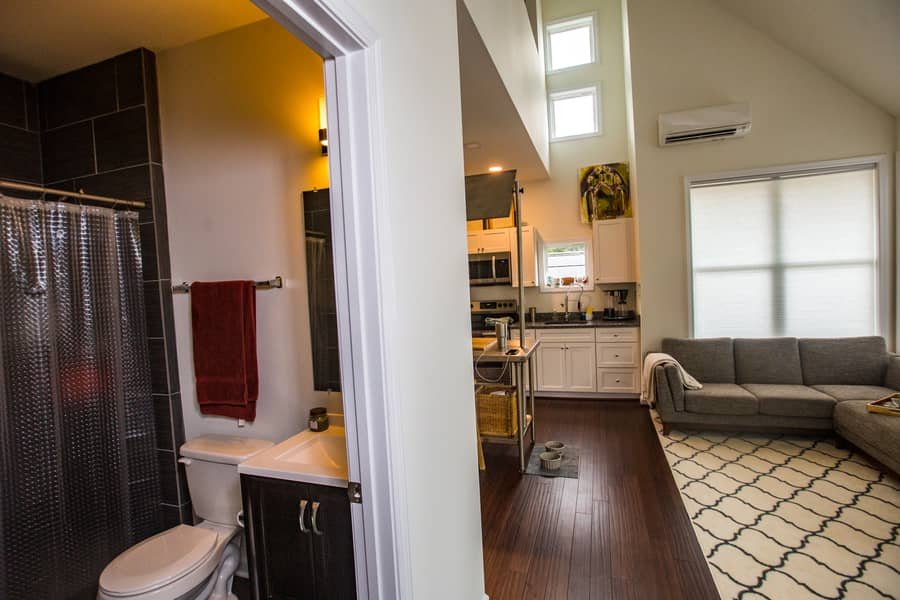 Bright cottage interior with natural light, wood accents, and efficient tiny home layout.