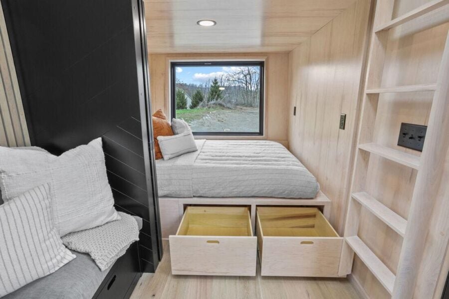 Under-bed drawer storage inside the first-floor bedroom of the Sangja tiny home.