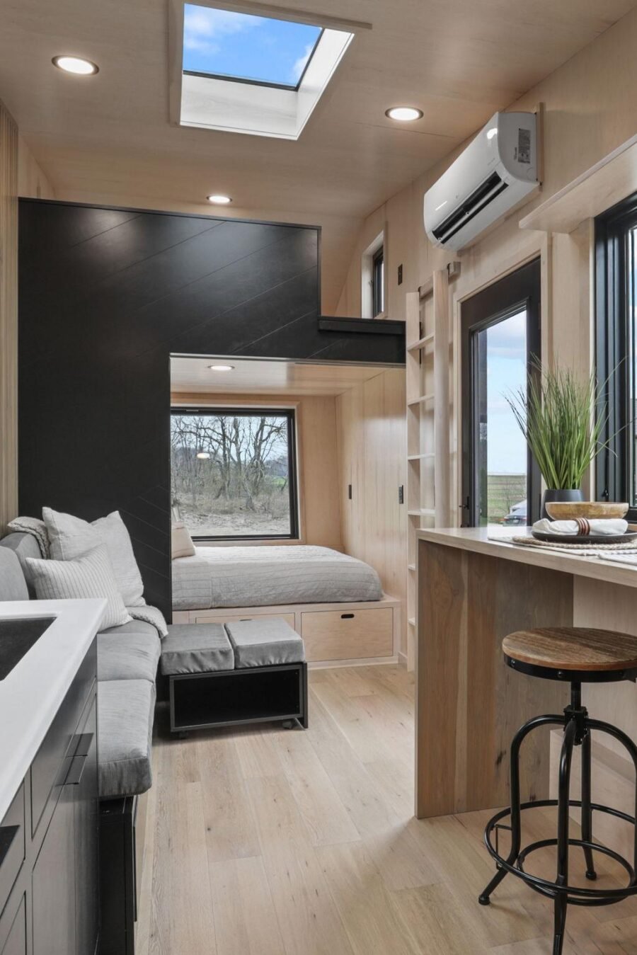 Maple ladder leading to the loft bedroom inside the Sangja tiny house by Modern Tiny Living.