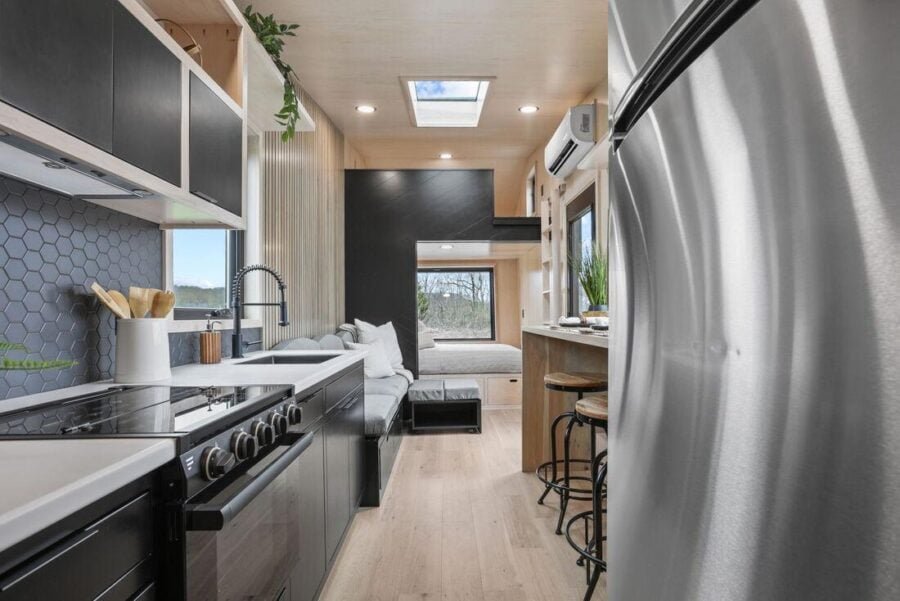 Custom kitchen cabinetry in the Sangja tiny home combining open shelving and closed storage.