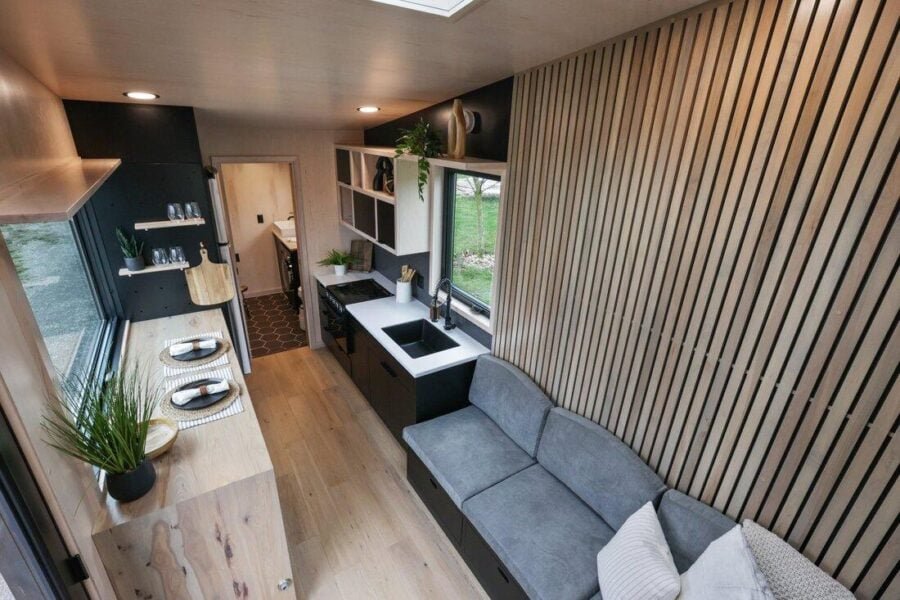 Living area of the Sangja tiny house featuring a large skylight, wood accents, and bright natural light.