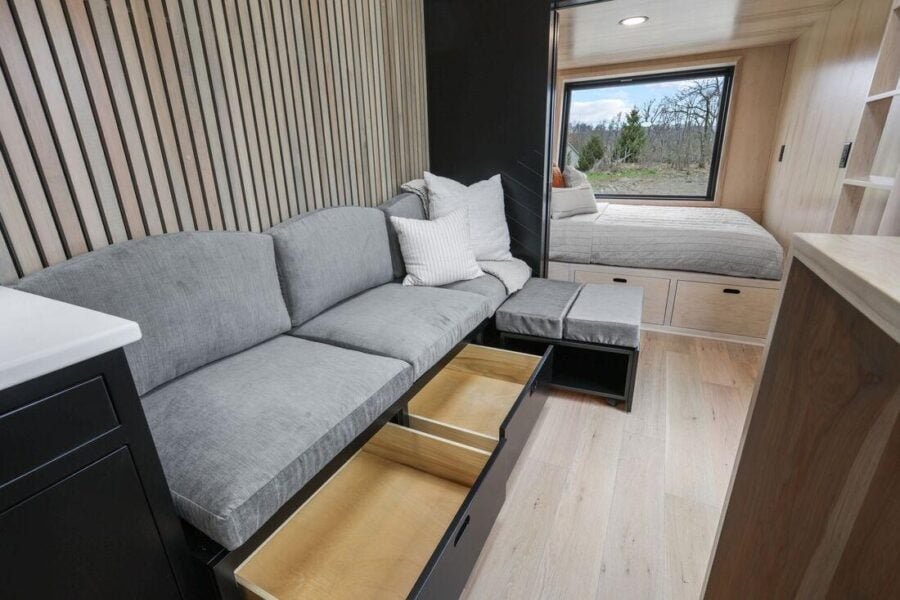 Living room sofa in the Sangja tiny house with deep drawer storage underneath.