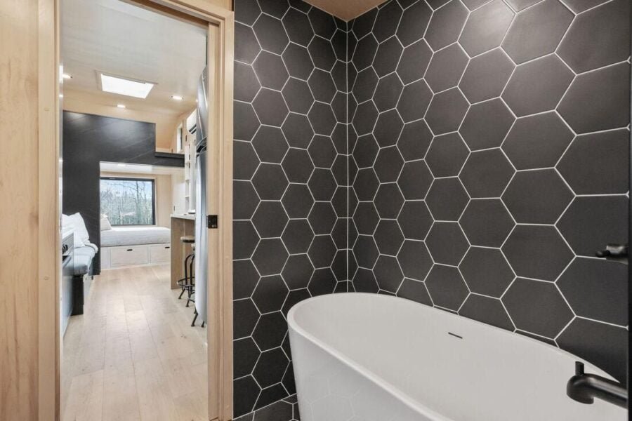 Freestanding soaking tub inside the Sangja tiny house bathroom.